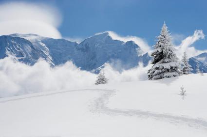 Fresh snow and cloud spilling over mountains in the Alps