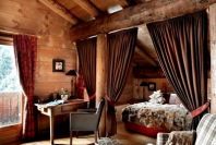 Cosy rustic chic bedroom in the 5-star luxury hotel Les Fermes de Marie in, Megève, France - Snow-wise - Best ski hotels in the Alps for traditional luxury