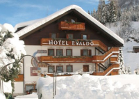 Exterior of the luxury 4-star family-run  Hotel Evaldo in Arabba, Italy, with its stunning Dolomite views, swimming pool, spa and convenient location close to the ski lifts