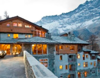 Exterior of the luxury 5-star Saint Hubertus Resort & Spa in Cervinia, Italy, with its exquisite luxury apartments, fabulous spa and swimming pool, stunning Matterhorn views, and gourmet dining.