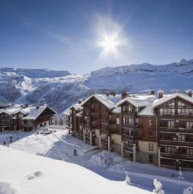 Exterior of the slopeside, ski-in/ski-out luxury 5-star Les Terrasses d’Eos self-catering apartments offering panoramic mountain views, and spa facilities including heated outdoor pool.