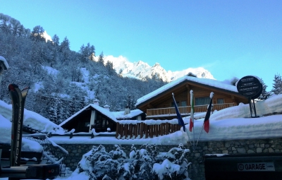 View of snow-covered hotel Pilier d'Angle ***, Courmayeur, Italy, with panoramic mountain scenery