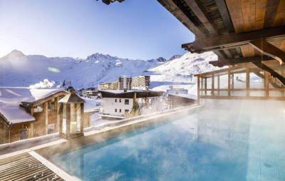 View from the outdoor pool of the 4 star Hotel Campanules in Tignes, France with snow covered mountains behind