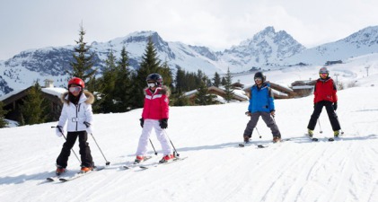 Children skiing on snow-covered piste in Courchevel, France - Snow-wise luxury ski holidays at February Half Term 2025