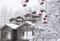 Snow-clad exterior of the luxury 5-star boutique CERVO Mountain Resort hotel in Zermatt, Switzerland with its Matterhorn views, contemporary chalet-style, ski-in/ski-out access,  gourmet dining and state-of-the-art spa
