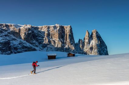 Stunning Dolomite views from the sno-covered Alpe di Siusi, Italy, with access to the vast Super Dolomiti ski area.
