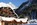 Snow-covered exterior of the luxury 4-star Hotel Les Grands Montets in Argentiere, in Chamonix, France with its spa and swimming pool, with its easy access to the Grand Montets ski area and panoramic mountain views