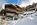 Snowy ski-in/ski-out exterior of the luxury 5-star boutique CERVO Mountain Resort hotel in Zermatt, Switzerland with its Matterhorn views, contemporary chalet-style, ski-in/ski-out access,  gourmet dining and state-of-the-art spa