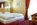 Bedroom of the luxury 4-star family-run Hotel Evaldo in Arabba, Italy, with its stunning Dolomite views, swimming pool, spa and convenient location close to the ski lifts