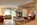 Lounge area with open fire in the interior of an apartment in the luxury 5-star Saint Hubertus Resort & Spa in Cervinia, Italy, with its exquisite luxury apartments, fabulous spa and swimming pool, stunning Matterhorn views, and gourmet dining.